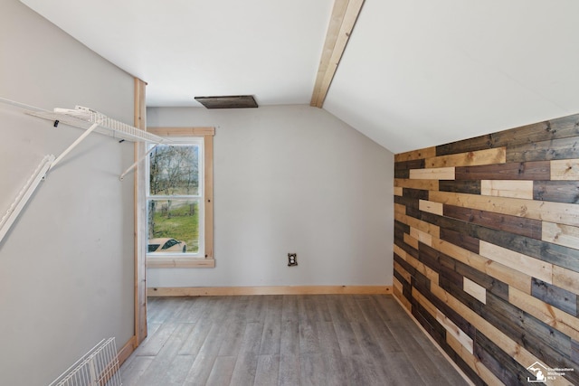 13280 Burt Rd, Pittsford, MI 49271 - bonus room featuring wooden walls, baseboards, lofted ceiling with beams, and wood finished floors