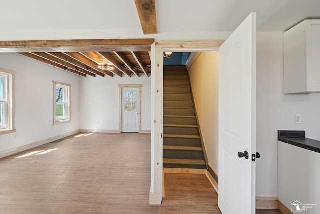 13280 Burt Rd, Pittsford, MI 49271 - stairs with baseboards, beamed ceiling, and wood finished floors