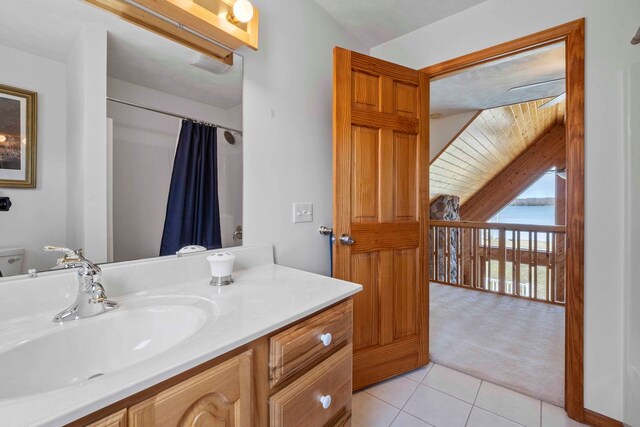 7734 N Shore Ct, Grawn, MI 49637 - bathroom featuring vanity, a water view, tile patterned floors, and a shower with shower curtain