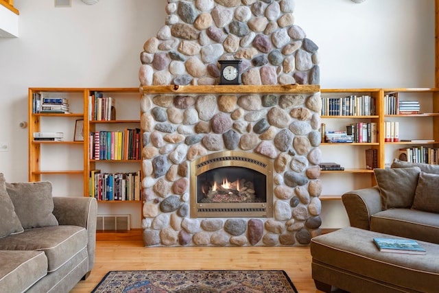 7734 N Shore Ct, Grawn, MI 49637 - living room with visible vents, wood finished floors, and a fireplace