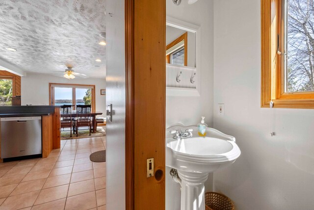 7734 N Shore Ct, Grawn, MI 49637 - bathroom with tile patterned flooring and ceiling fan