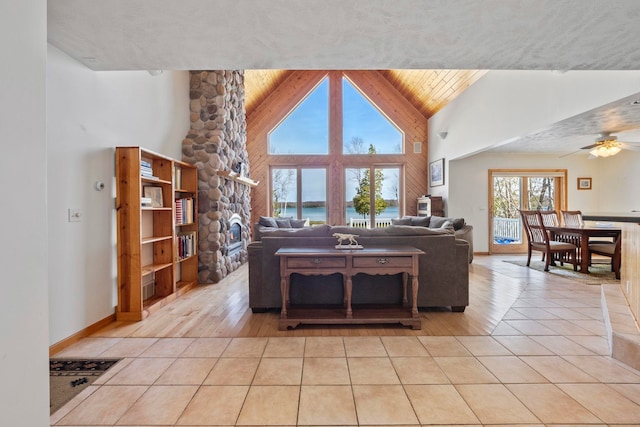 7734 N Shore Ct, Grawn, MI 49637 - living area featuring ceiling fan, light tile patterned floors, and high vaulted ceiling