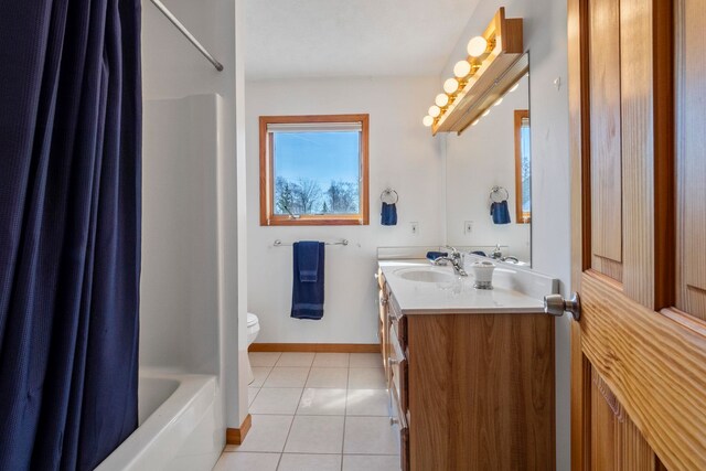 7734 N Shore Ct, Grawn, MI 49637 - bathroom featuring tile patterned flooring, shower / tub combo, vanity, baseboards, and toilet