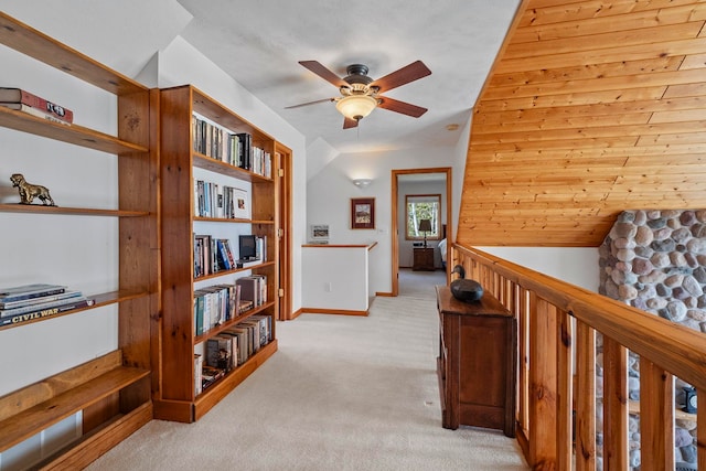 7734 N Shore Ct, Grawn, MI 49637 - corridor with light colored carpet, lofted ceiling, and an upstairs landing