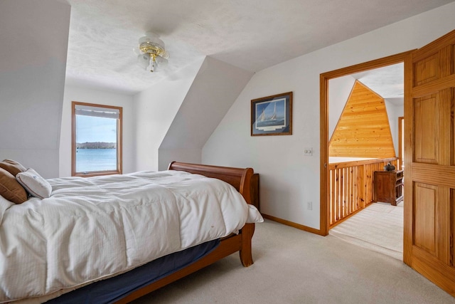 7734 N Shore Ct, Grawn, MI 49637 - bedroom with a ceiling fan, baseboards, wood walls, and light carpet