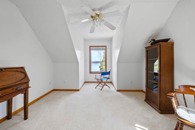 7734 N Shore Ct, Grawn, MI 49637 - additional living space with a ceiling fan, baseboards, light colored carpet, and lofted ceiling