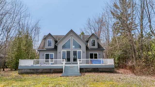 7734 N Shore Ct, Grawn, MI 49637 - rear view of house with a yard and a wooden deck