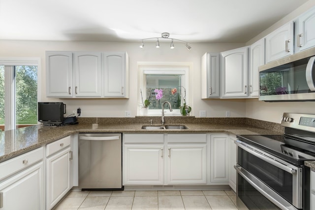 kitchen with white cabinets, stainless steel appliances, and a sink