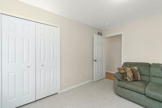 living area featuring baseboards, carpet, and visible vents