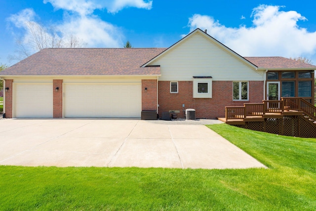 back of property featuring an attached garage, driveway, and brick siding