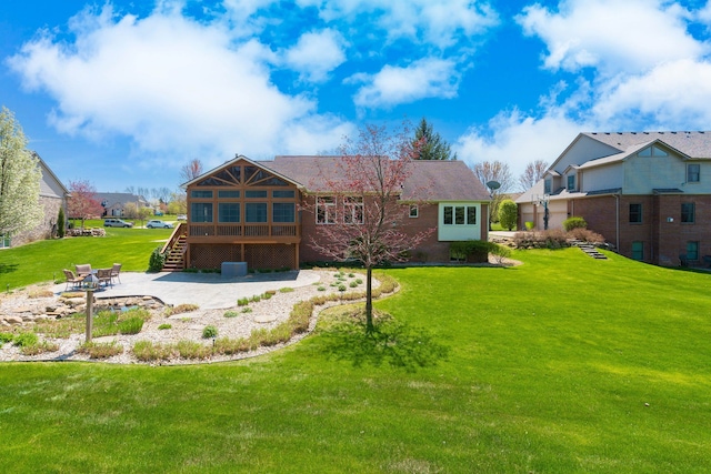 rear view of property with a yard, a patio, a wooden deck, and stairs