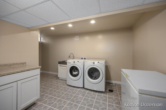 laundry area with baseboards, recessed lighting, and separate washer and dryer