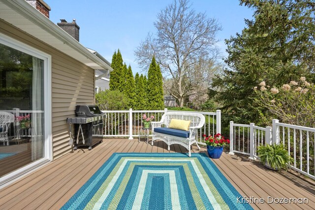 wooden terrace featuring a grill