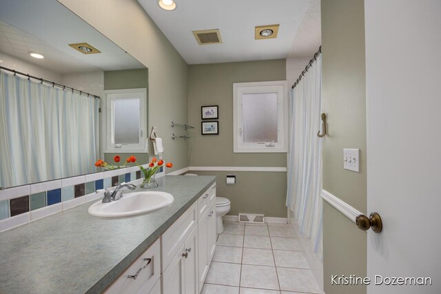 full bath with visible vents, tile patterned flooring, toilet, and vanity