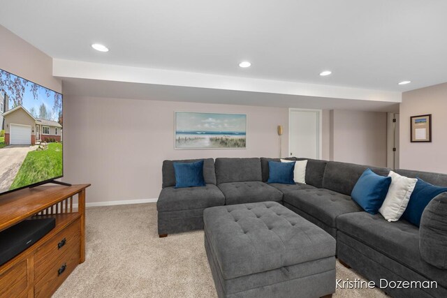 living area featuring baseboards, recessed lighting, and light colored carpet