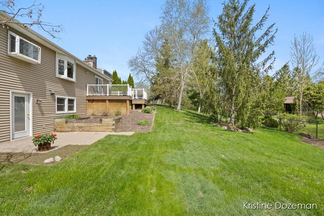 view of yard featuring fence and a deck