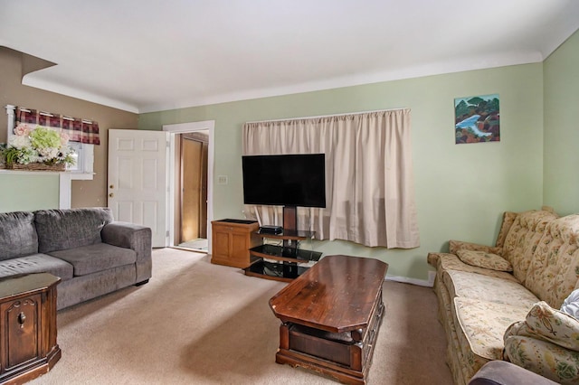 carpeted living area with baseboards