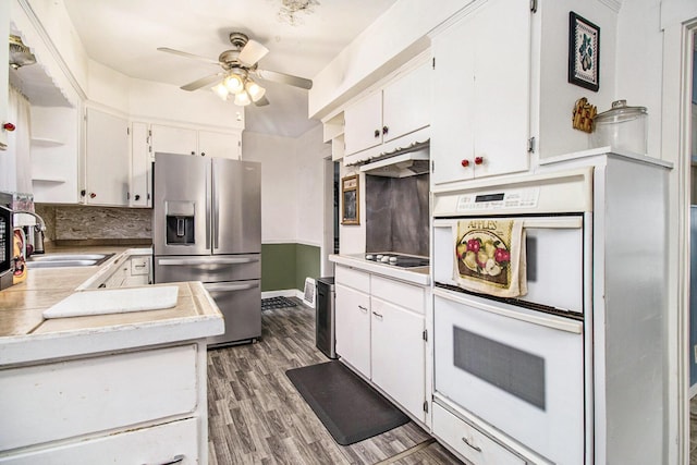kitchen with ceiling fan, light countertops, white double oven, stainless steel fridge, and white cabinetry