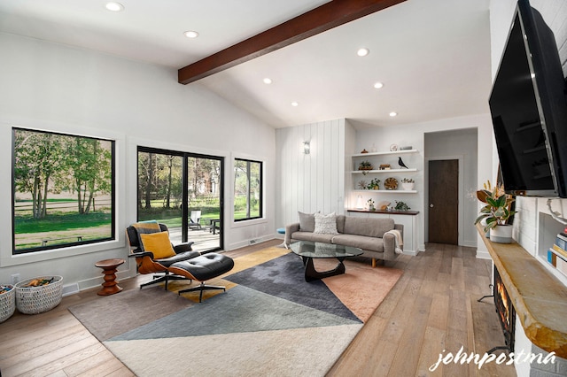 living room featuring recessed lighting, lofted ceiling with beams, and light wood-type flooring
