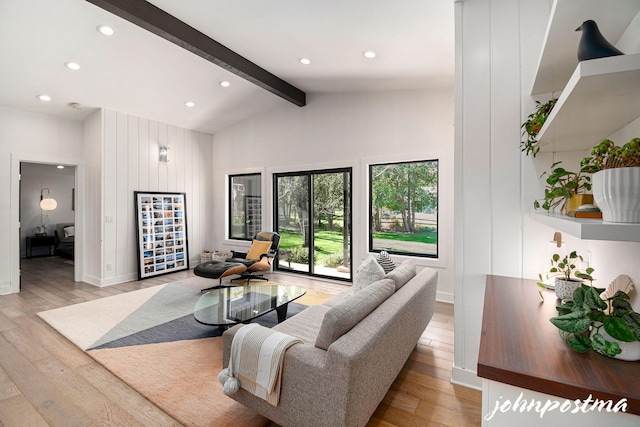 living room featuring recessed lighting, beam ceiling, and light wood finished floors