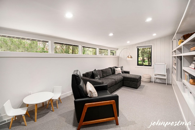 carpeted living area with recessed lighting, visible vents, and lofted ceiling