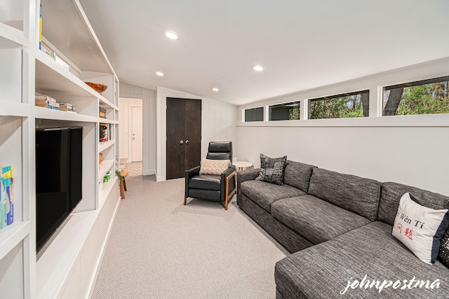 living area featuring recessed lighting, lofted ceiling, and light carpet