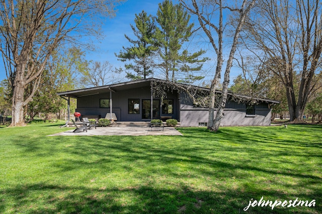 back of property featuring a yard and a patio