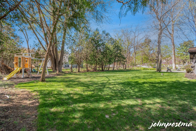 view of yard with fence and a playground