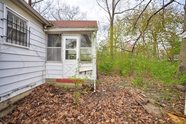 view of home's exterior with a sunroom