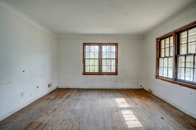 empty room with wood finished floors and visible vents