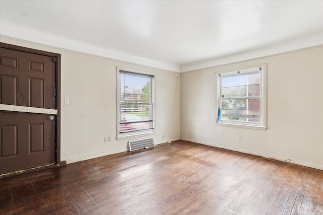 foyer with wood finished floors and baseboards