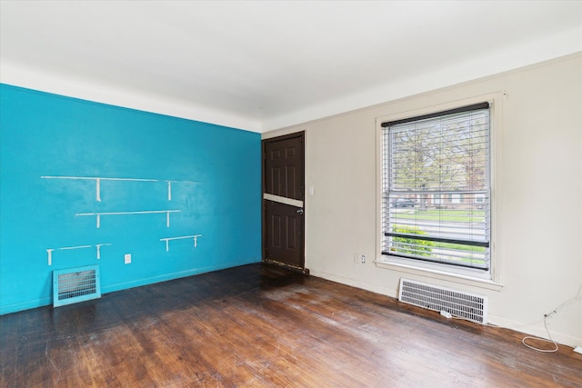 empty room with wood finished floors and baseboards