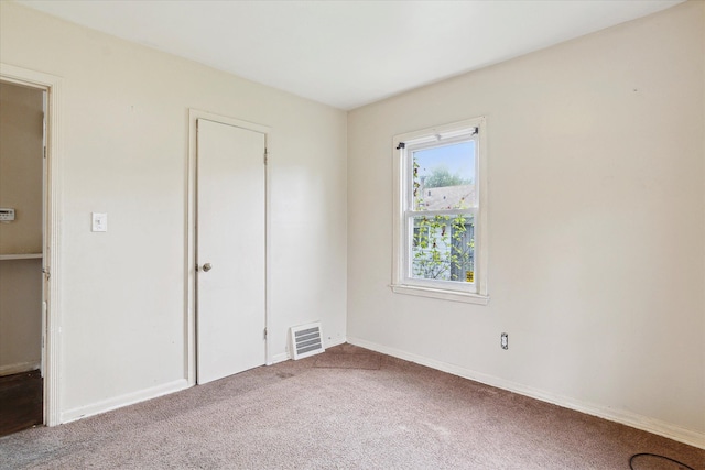 unfurnished bedroom featuring carpet flooring and baseboards