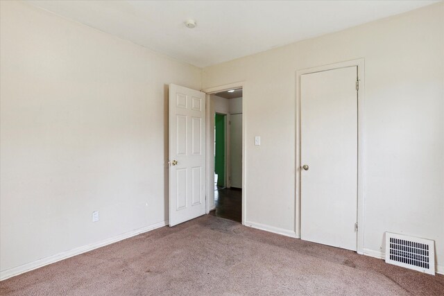 unfurnished bedroom with carpet floors and baseboards