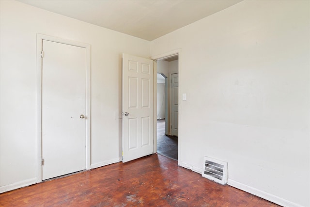 unfurnished bedroom featuring baseboards and wood finished floors