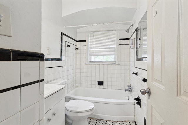 full bath featuring tile walls, toilet, vanity, shower / tub combination, and tile patterned flooring