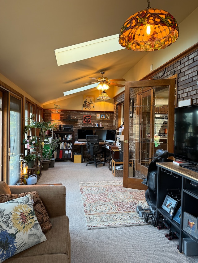 55535 Woody Ln, South Lyon, MI 48178 - carpeted living area featuring brick wall, a ceiling fan, french doors, and vaulted ceiling with skylight