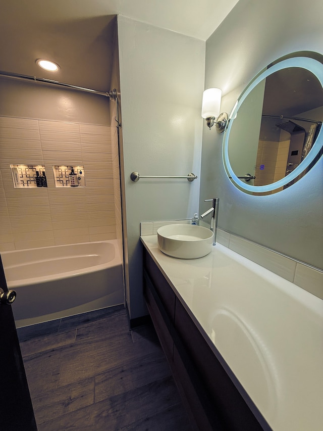 55535 Woody Ln, South Lyon, MI 48178 - bathroom with double vanity, wood finished floors, shower / bathtub combination, and a sink