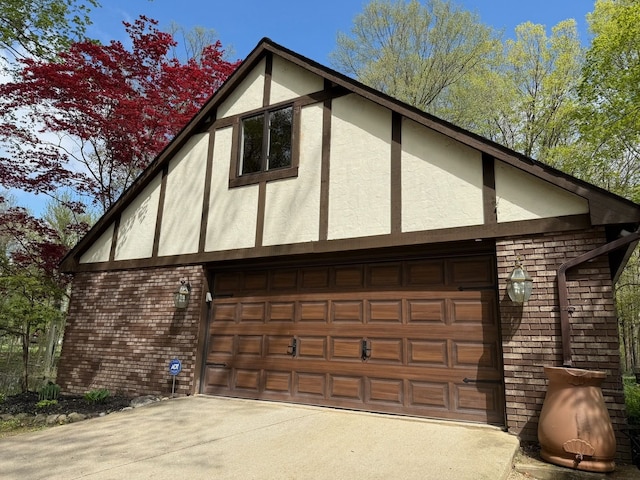 55535 Woody Ln, South Lyon, MI 48178 - view of home's exterior featuring concrete driveway, stucco siding, and brick siding