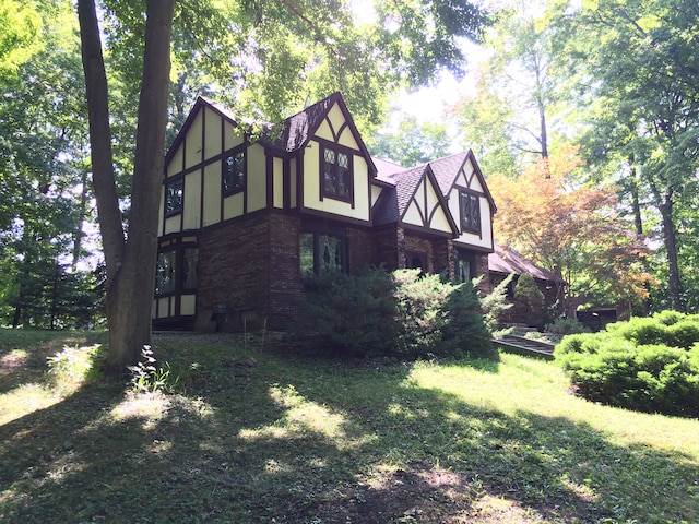 55535 Woody Ln, South Lyon, MI 48178 - view of home's exterior with brick siding, a yard, and stucco siding