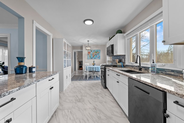 kitchen featuring black microwave, dishwasher, gas stove, a sink, and marble finish floor