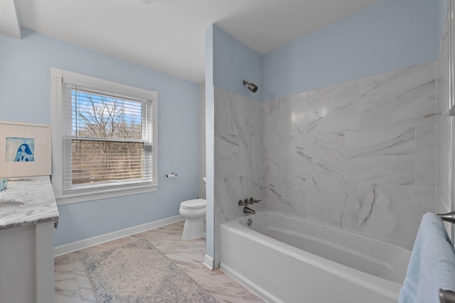full bathroom featuring baseboards, vanity, toilet, marble finish floor, and bathing tub / shower combination