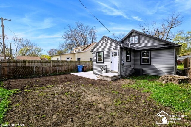 back of property with a patio, cooling unit, and a fenced backyard