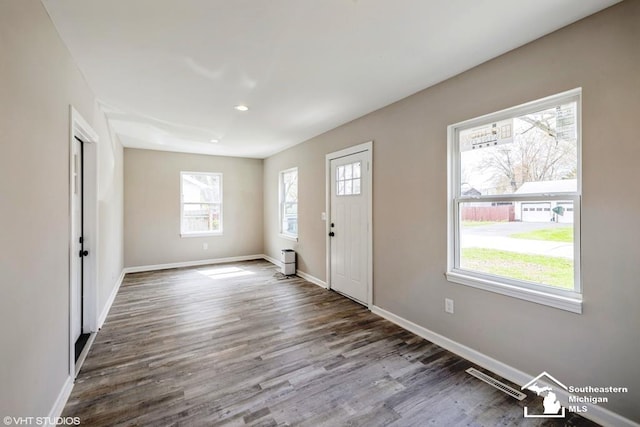 entryway featuring baseboards, recessed lighting, wood finished floors, and visible vents