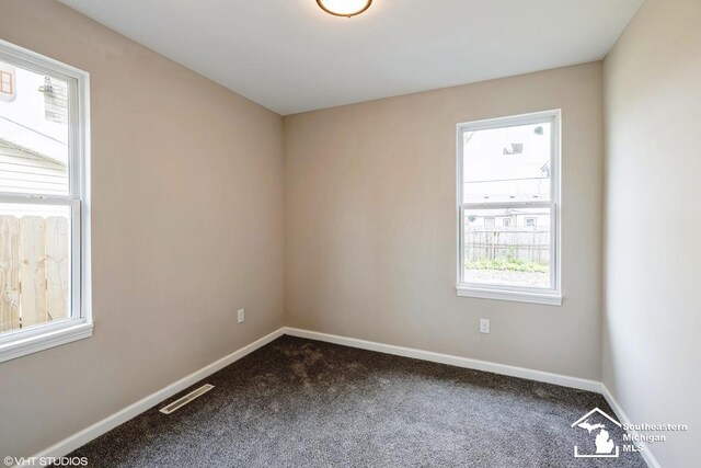 unfurnished room with baseboards, carpet flooring, and visible vents
