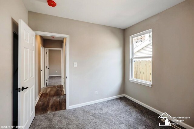unfurnished bedroom with carpet floors and baseboards