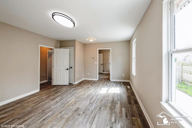 unfurnished bedroom featuring baseboards and wood finished floors