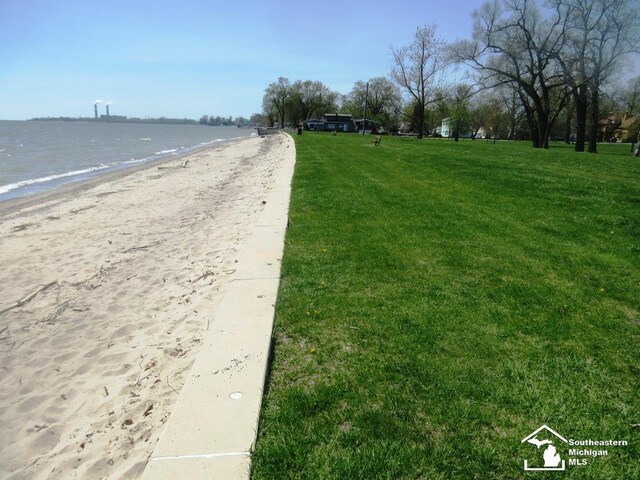 view of road featuring a water view and a view of the beach