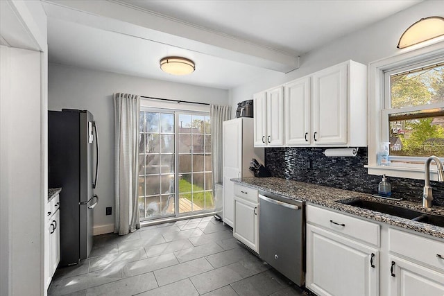 kitchen featuring a sink, tasteful backsplash, a wealth of natural light, and stainless steel appliances