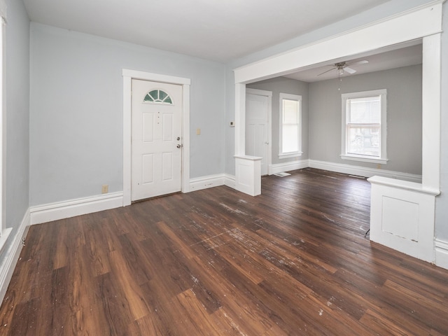 foyer entrance with baseboards, a ceiling fan, and dark wood finished floors